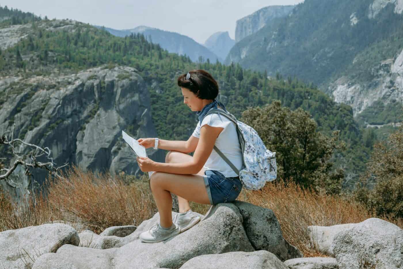 Mountain hike. Woman admiring epic mountains view. Travel and explore concept.